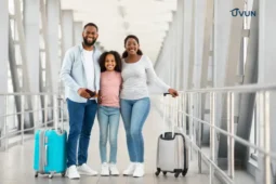 Família negra sorridente com malas em um aeroporto, representando o sonho de viajar pelo Brasil com economia.